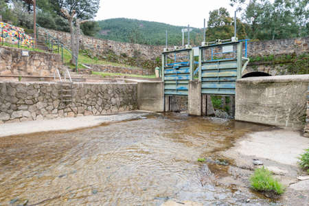 Downloadmaria, Spain - March 27, 2021: Open dam in the natural pool in the Arrago river to bathe in...