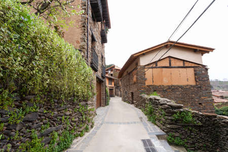 Robledillo de Gata, Spain - March 27, 2021: The vegetation of the orchards of the houses invades the streetsのeditorial素材