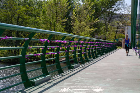Pieces of purple cloth tied to a bridge on International Women's Day, each tie bears the name of a woman who is a victim of gender based violenceのeditorial素材