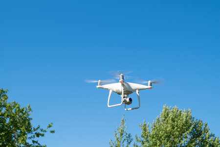 Drone or quadrocopter while flying in the sky.