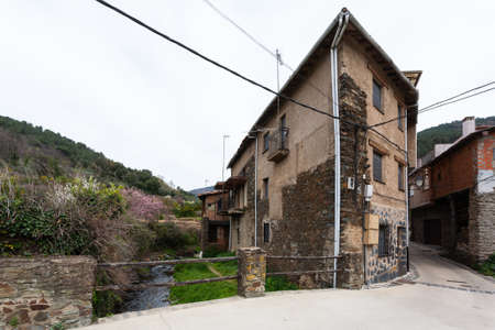 Robledillo de Gata, Spain - March 27, 2021: A typical adobe, slate and wood house built next to a...