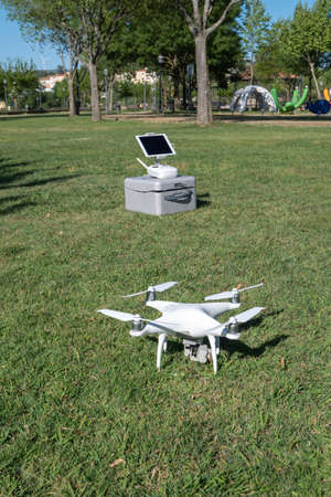 A drone with its controlling station and transport box waits to be piloted over the city