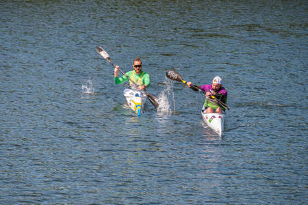 Plasencia, Spain - April 24, 2021: Two young men practices canoeing riding in his canoe navigating the Jerte riverのeditorial素材
