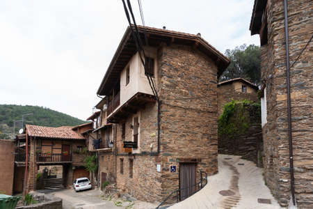 Robledillo de Gata, Spain - March 27, 2021: Stone hermitage with bell tower and large wooden door...
