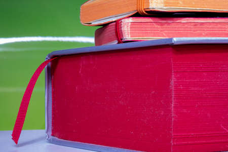 Pile of old books side view isolated on green background