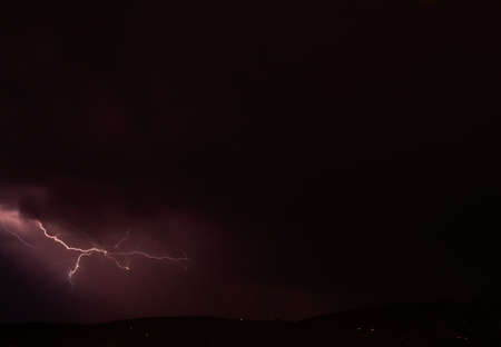 Lightning storm in the dark cloud sky illuminated by the glare of lightning