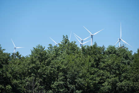 Wind turbines on beautiful sunny summer autumn mountain landsapeの写真素材