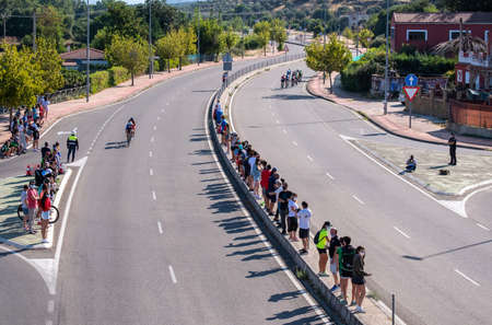 Fitness athletes pedaling their bikes during a national Triathlon, swimming, cycling and running...