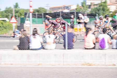 Fitness athletes pedaling their bikes during a national Triathlon, swimming, cycling and running...
