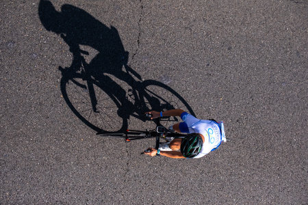 Fitness athletes pedaling their bikes during a national Triathlon, swimming, cycling and running events.のeditorial素材