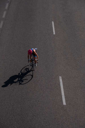 Triathlon swim bike run triathlete man training for ironman race concept. Professional cyclist, runner, swimmer.のeditorial素材
