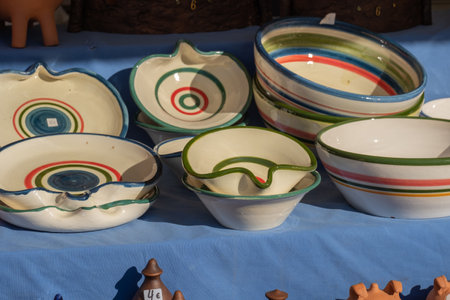 Collection of colorful ceramic pottery, plates and bowls are local craft products from Spain....
