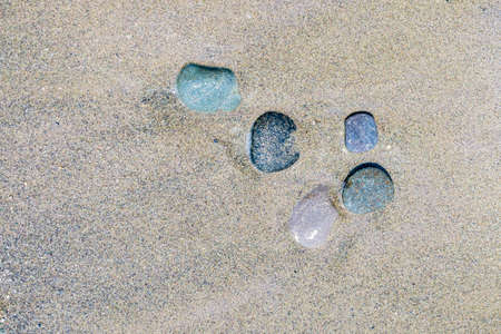 Several boulders by the beachSeveral semi-submerged boulders in the sand on the beach