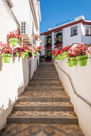 Estepona, Malaga, Spain - June 07, 2022: Typical Andalusian street decorated with pots and flowers in Estepona, Costa del Sol, Spainのeditorial素材