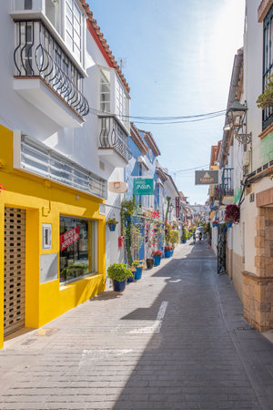 Estepona, Malaga, Spain - June 07, 2022: Typical Andalusian street decorated with pots and flowers in Estepona, Costa del Sol, Spainのeditorial素材