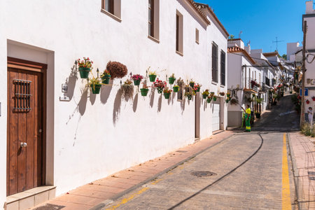 Estepona, Malaga, Spain - June 07, 2022: Operators from the Estepona town hall watering the pots full of colorful flowers that are found throughout the cityのeditorial素材