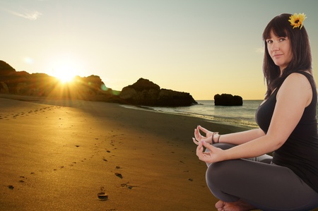 attractive sporty girl makes yoga in sunriseの写真素材