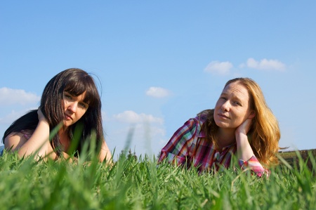 two beautiful girls are in the green grassの写真素材