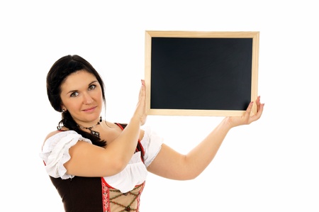 pretty woman in dirndl with empty billboardの写真素材