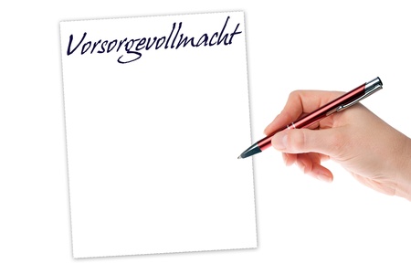 Hand with pen writing the german words Durable power of attorneyの写真素材
