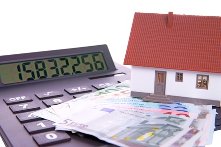 small house with calculator and euro moneyの写真素材