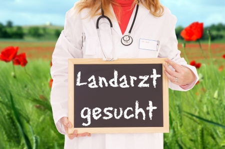 Doktor with sign and the german words Looking for a country doctorの写真素材