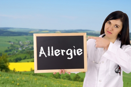 Doctor with sign and the german word Allergyの写真素材