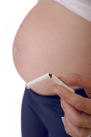 pregnant woman with a broken cigaretteの写真素材
