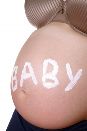 pregnant woman with naked belly and the word babyの写真素材