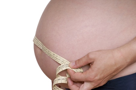 pregnant woman with measure tapeの写真素材