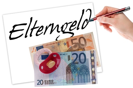 hand with pen writes the german words parents money and euro money with pacifierの写真素材
