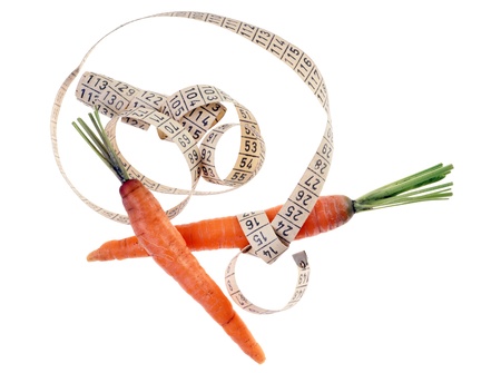 carrots with measure tape isolated over a white backgroundの写真素材
