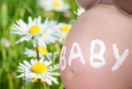 pregnant woman and daisiesの写真素材