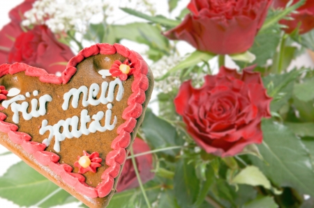 gingerbread heart with the german words for my Spatzi and red rosesの写真素材