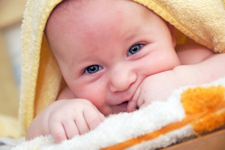 3 month old baby with towelの写真素材
