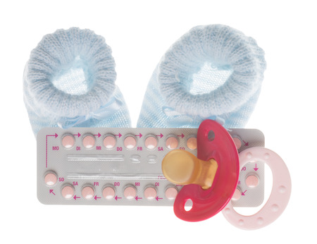 birth control pills and condom isolated over a white background