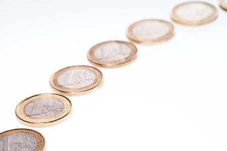 Euro coins in a row isolated over a white の写真素材