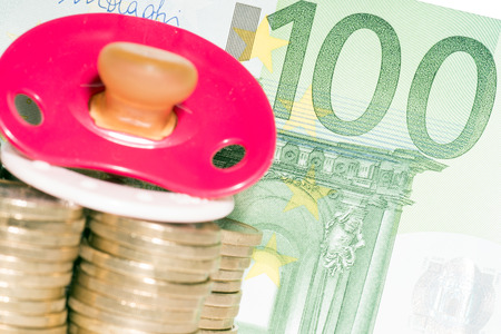Pacifier with euro coins and banknoteの写真素材