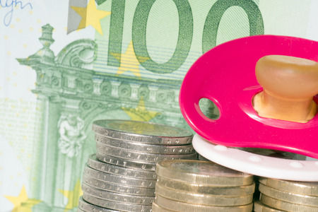 Pacifier with euro coins and banknoteの写真素材