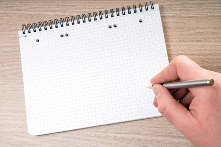 blank writing pad with hand and pen