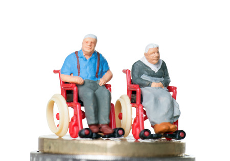 Old couple in a wheelchair with euro moneyの写真素材