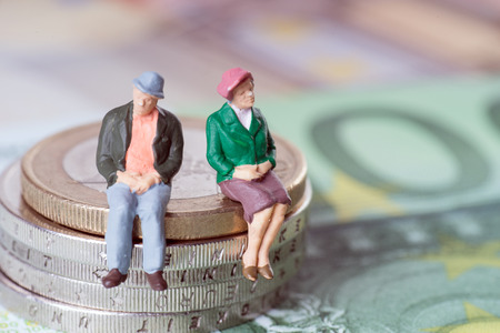 Grandma and Grandpa on a stack of euro coinsの写真素材
