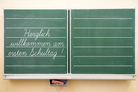 school blackboard with the german words Welcome to the first day of schoolの写真素材