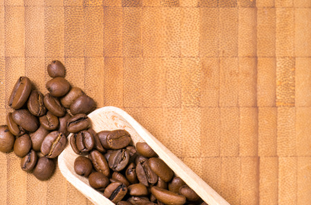 Coffee beans on a wooden boardの写真素材