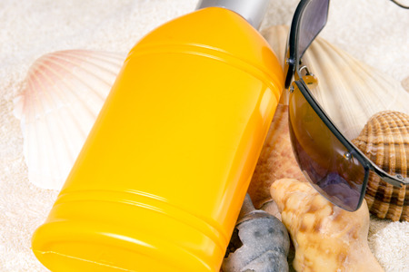 Sunscreen Cream with shells and sunglassesの写真素材