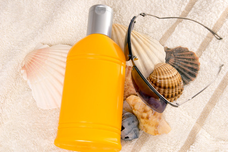 Sunscreen Cream with shells and sunglassesの写真素材
