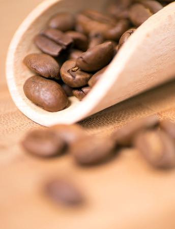 Coffee beans on a wooden boardの写真素材