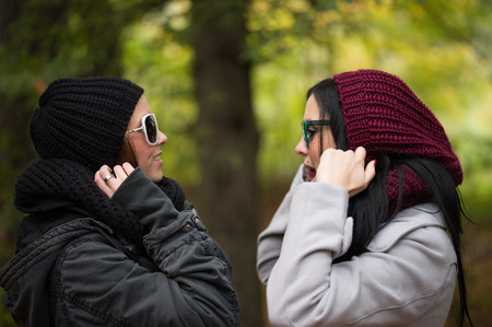 two girlfriends in an autumn forest