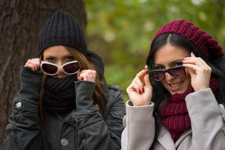 two girlfriends in an autumn forestの写真素材