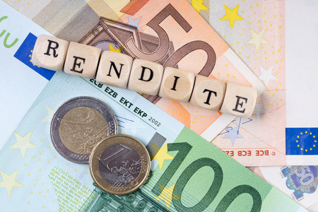 Euro Money and wood dice with the german word return onの写真素材